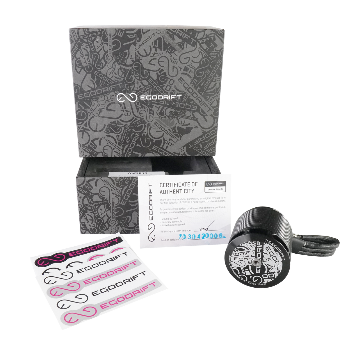 Opened box of the EGODRIFT Tengu 4230EC Eclipse motor with decal sheets on transparent background